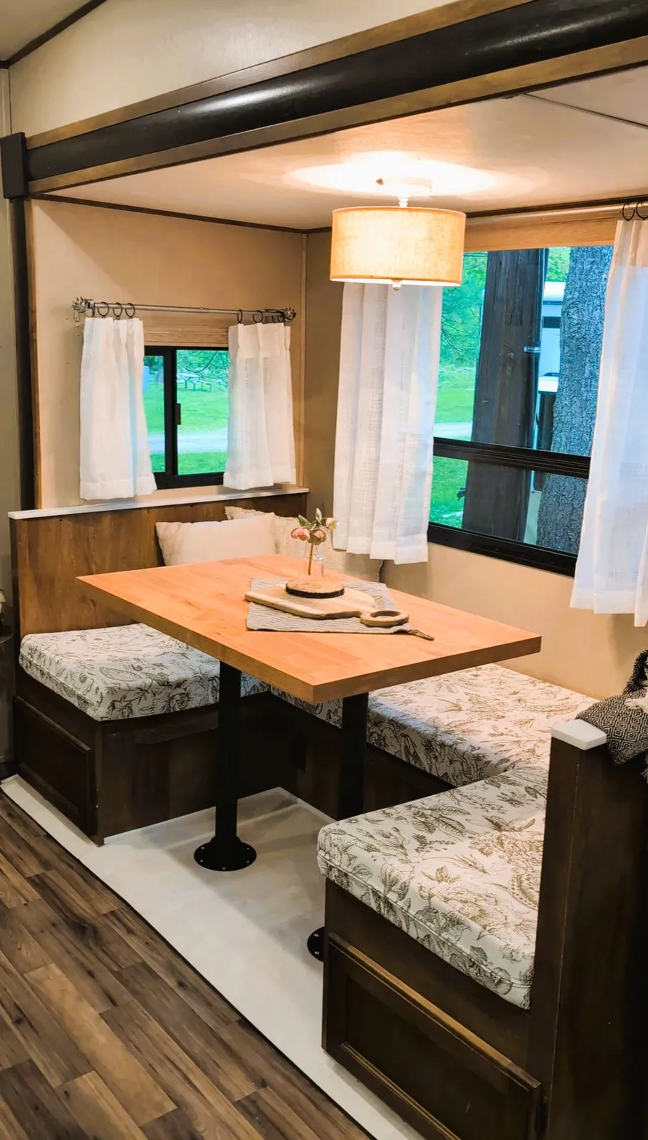 Inside the rental camper: a dinette with cushioned benches by the windows