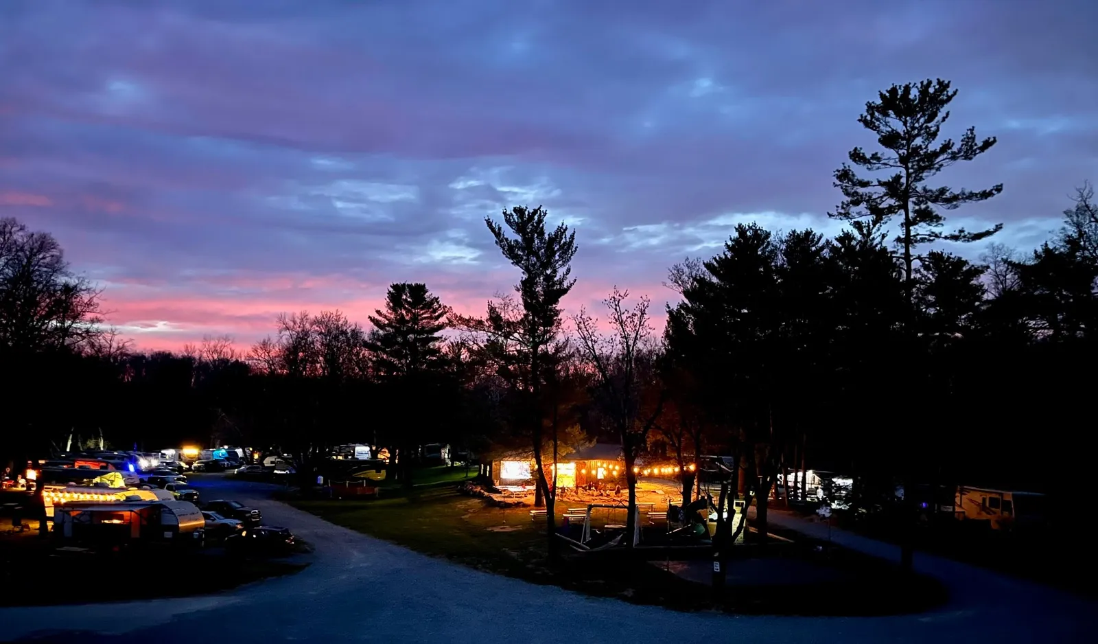 Campsite lights glowing along the loop road under a purple dusk sky