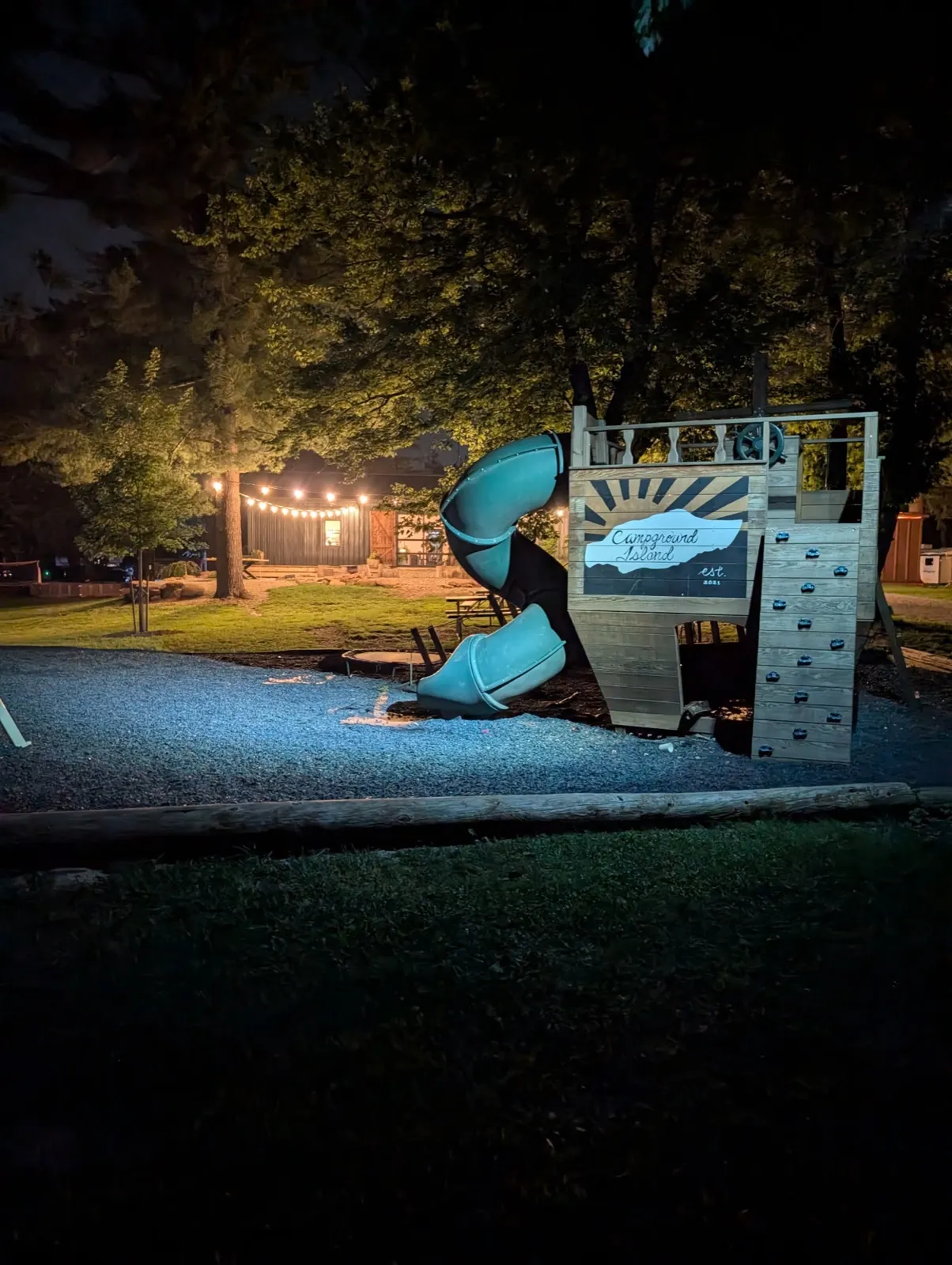 The pirate-ship playground and slide lit up at night